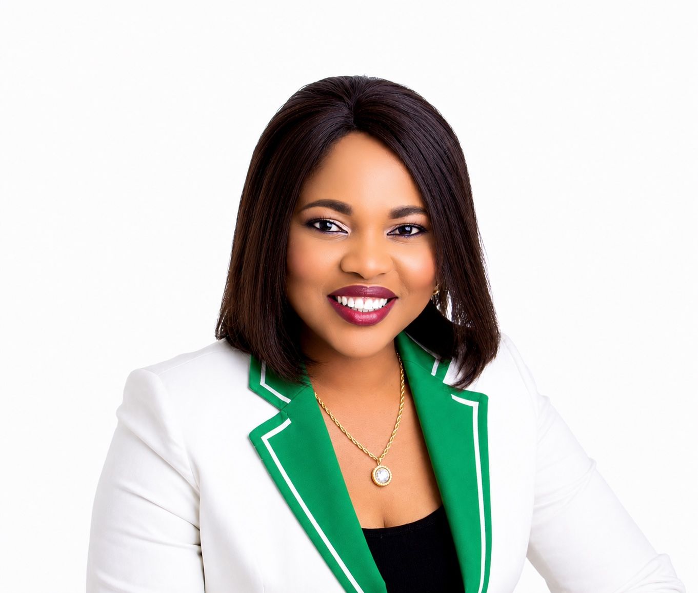 A woman in a blue jacket and white shirt smiles for the camera