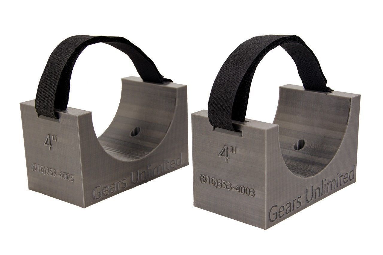 Two metal cable cleats with black straps, shown side by side on a white background