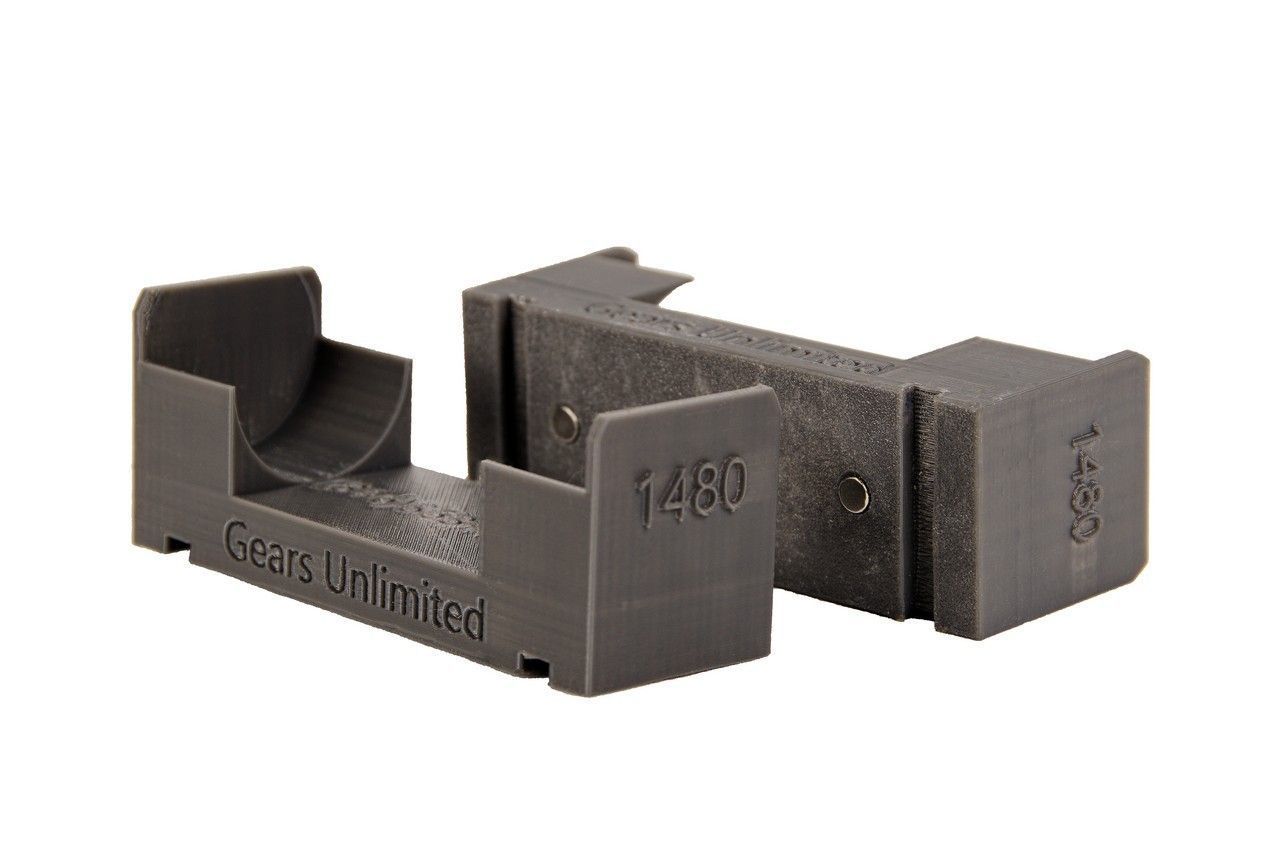 Black plastic cable clip with two open ends and embossed markings on a white background