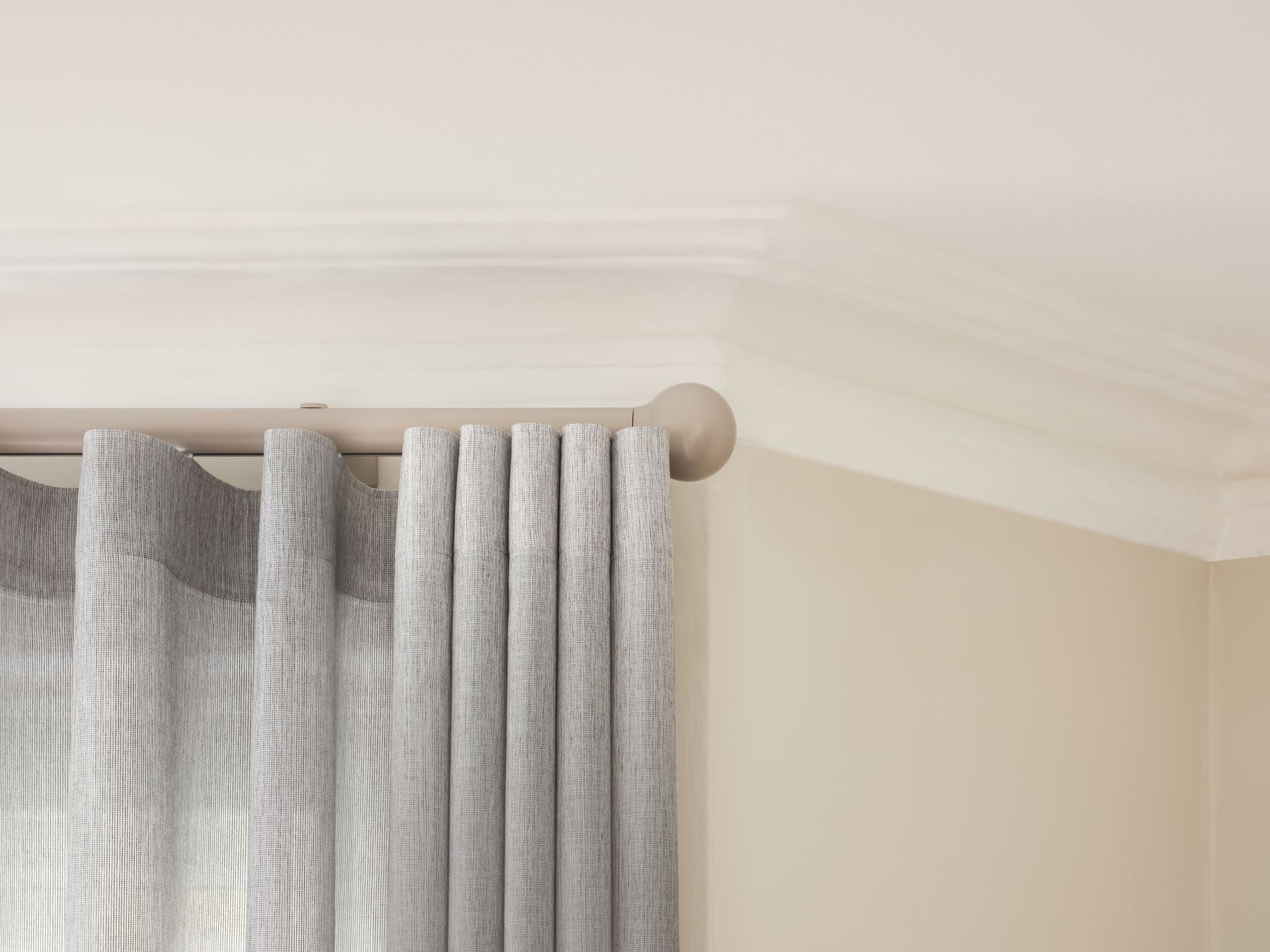A close up of a curtain hanging from the ceiling in a room.