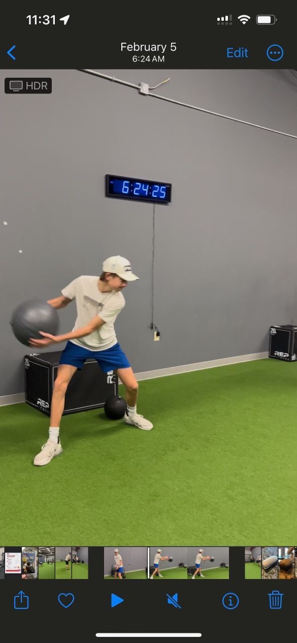 a man is holding a ball in a gym .