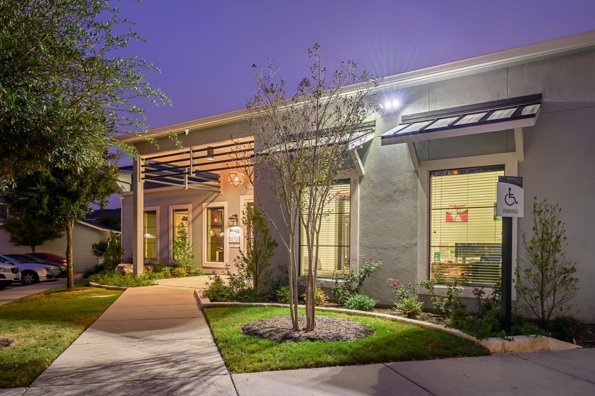 Exterior view of the leasing office with handicapped parking at Marquis SoCo in South Austin, TX.