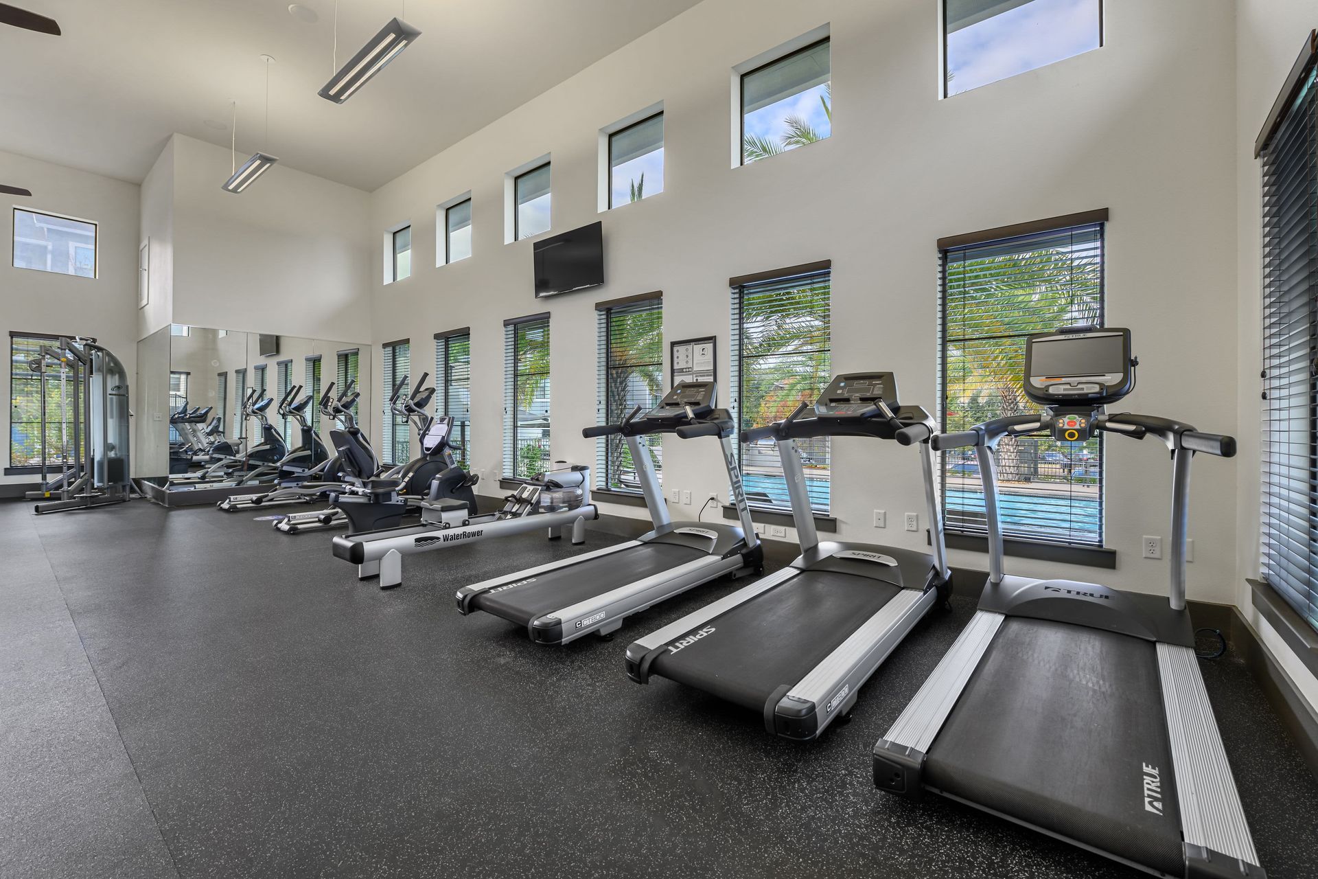Fitness center with a lot of treadmills and exercise bikes at Marquis SoCo in South Austin, TX.