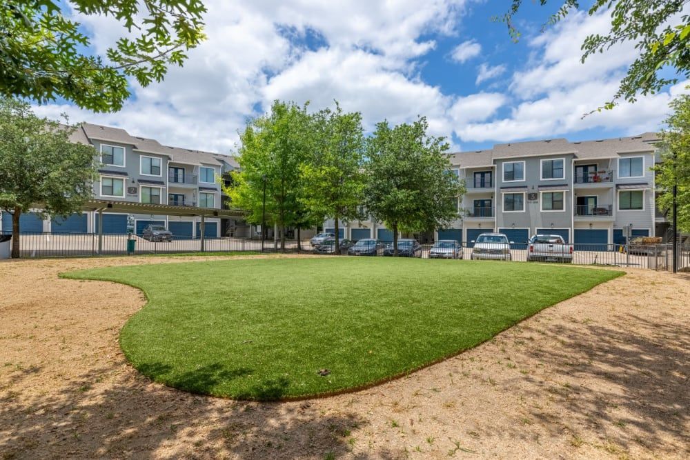 A large grassy area in front of
the apartment building at Marquis SoCo in South Austin, TX.