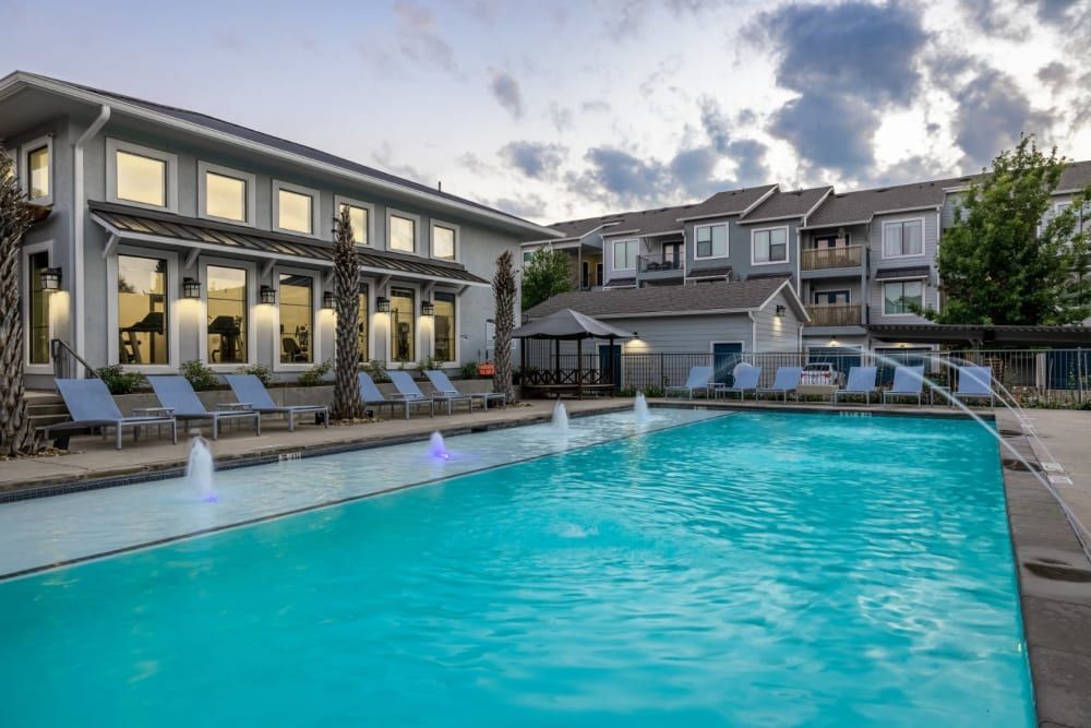 Swimming pool with poolside chairs at Marquis SoCo in South Austin, TX.