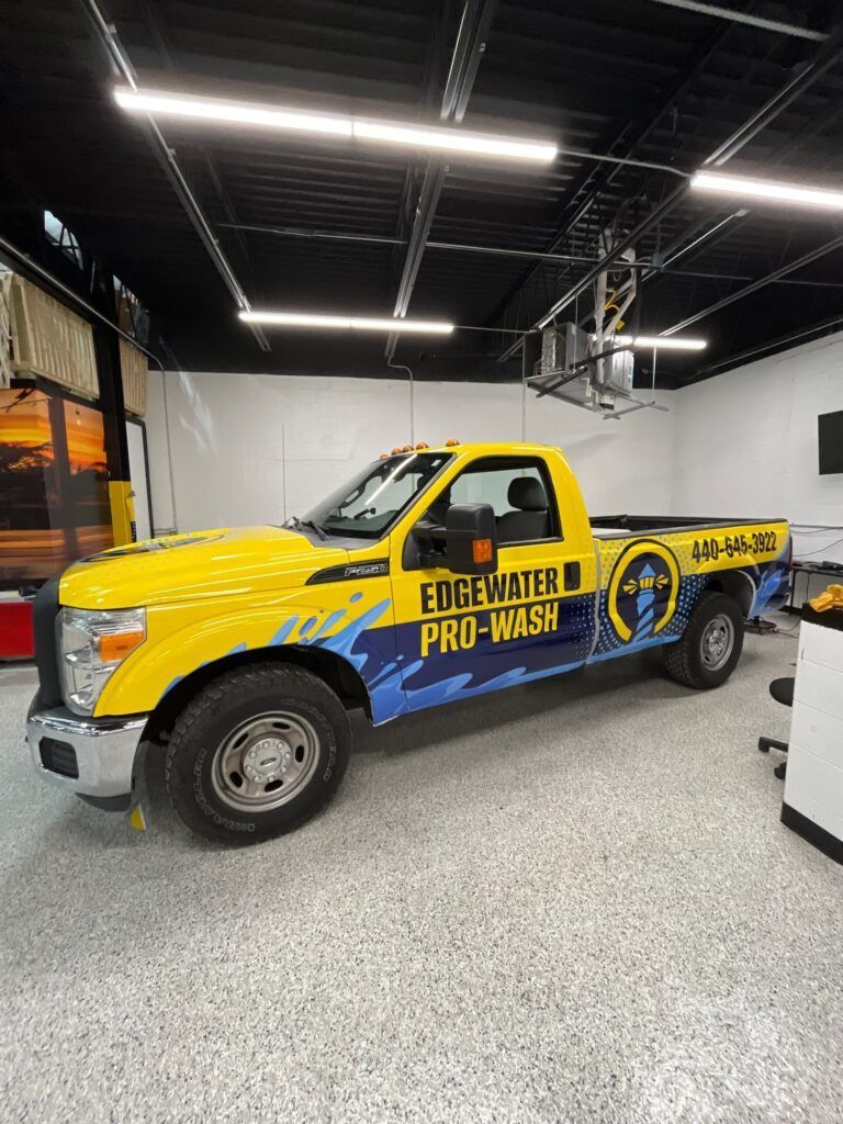 Yellow Edewaters Pro-Wash pickup truck parked indoors under bright shop lights