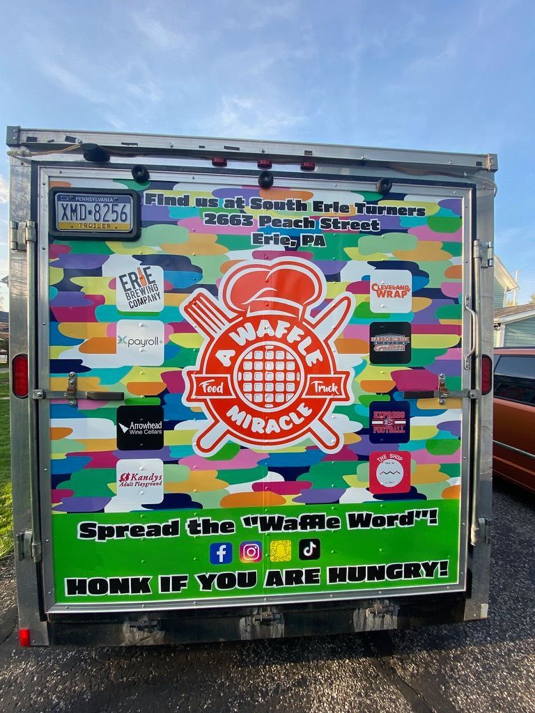 Colorful graffiti-covered truck rear with a large orange globe logo and social media icons