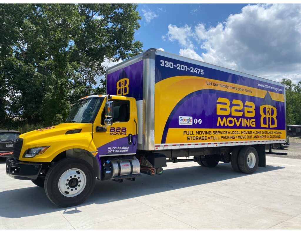 Yellow and purple B&B Moving box truck parked on a sunny street