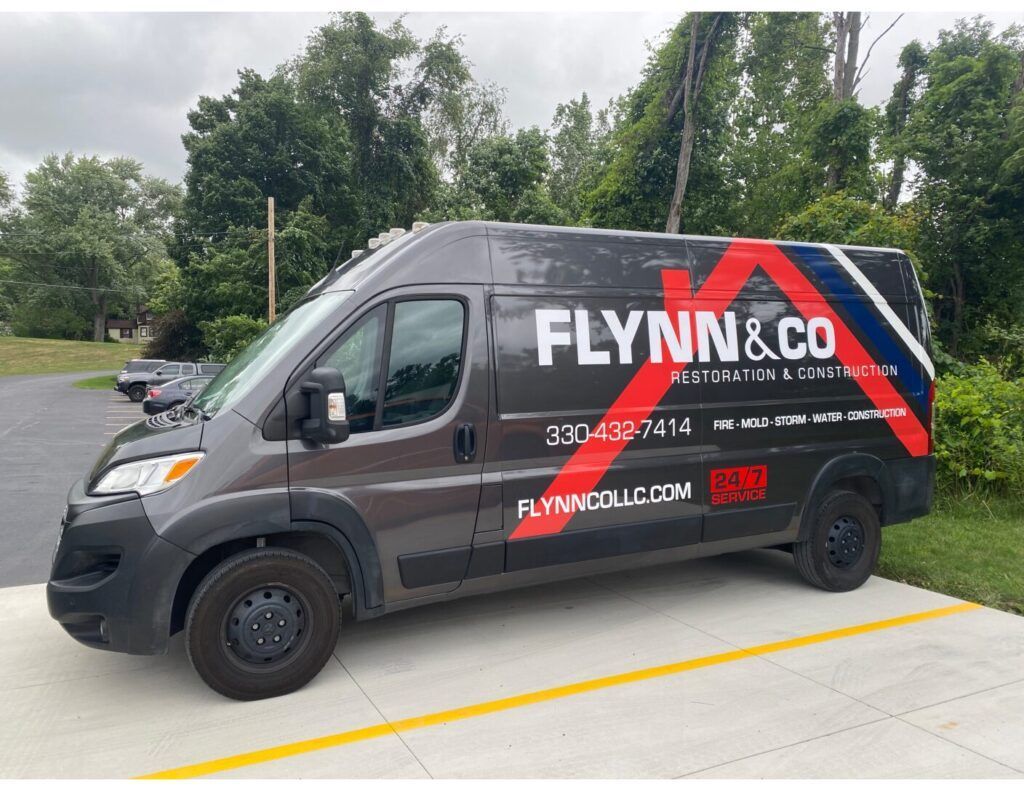 Flynn & Co. branded gray service van parked outdoors on a paved lot
