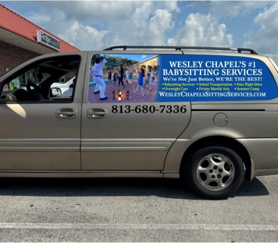A van that says wesley chapel 's # 1 babysitting services