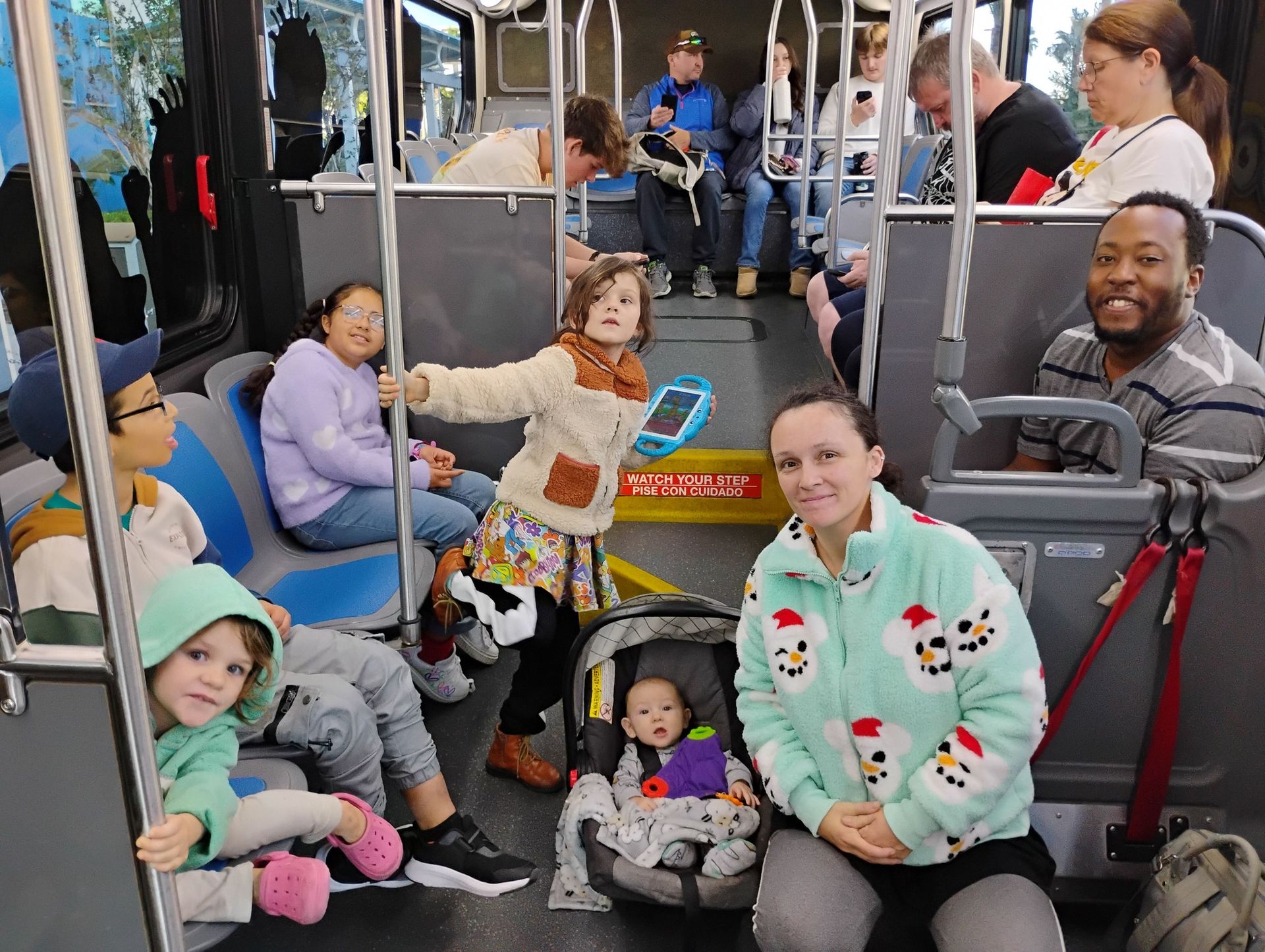 A group of people are sitting on a bus.