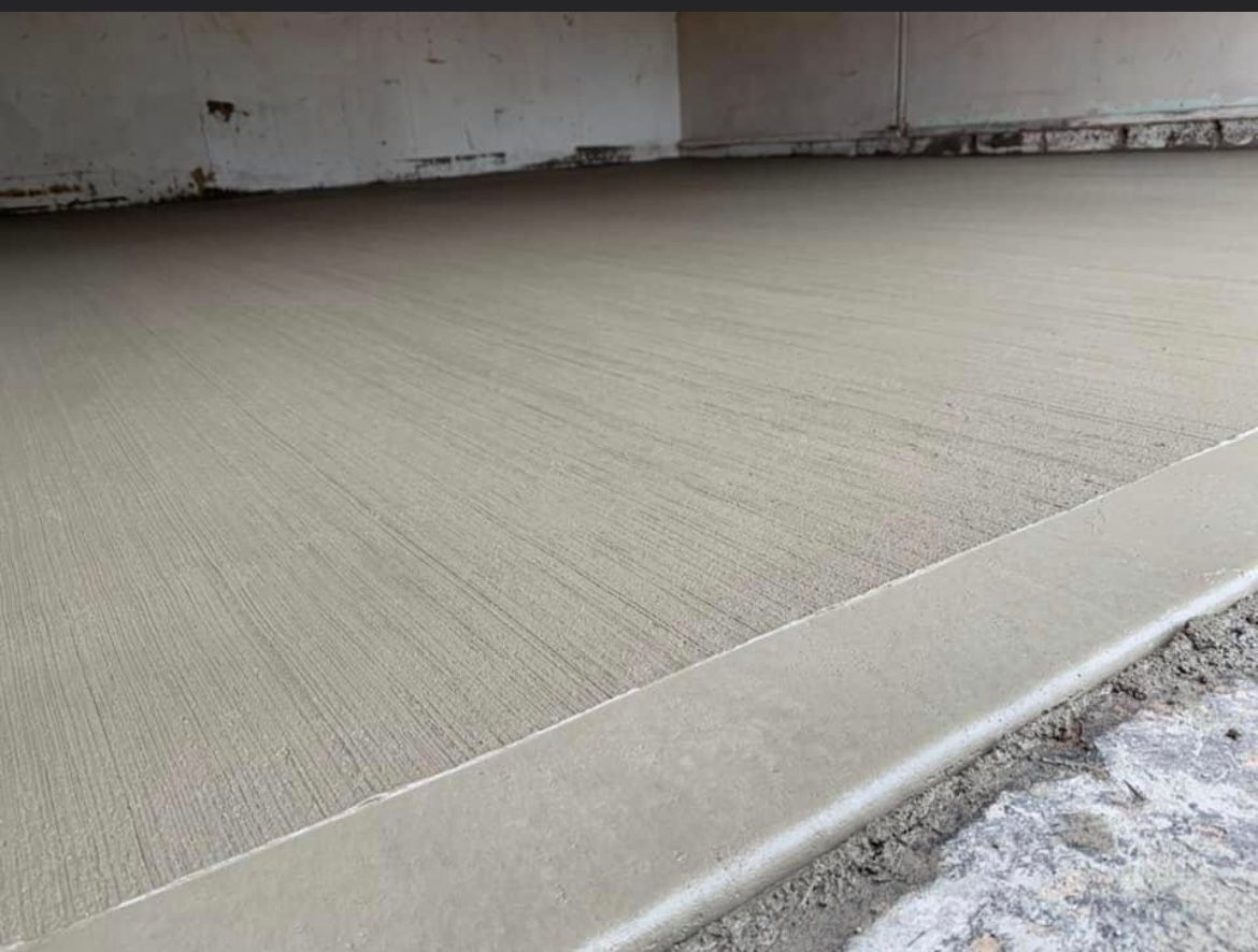 Universal Paving & Concrete applying a brushed concrete finish to a commercial walkway in Rochester, NY, ensuring a functional and slip-resistant surface.