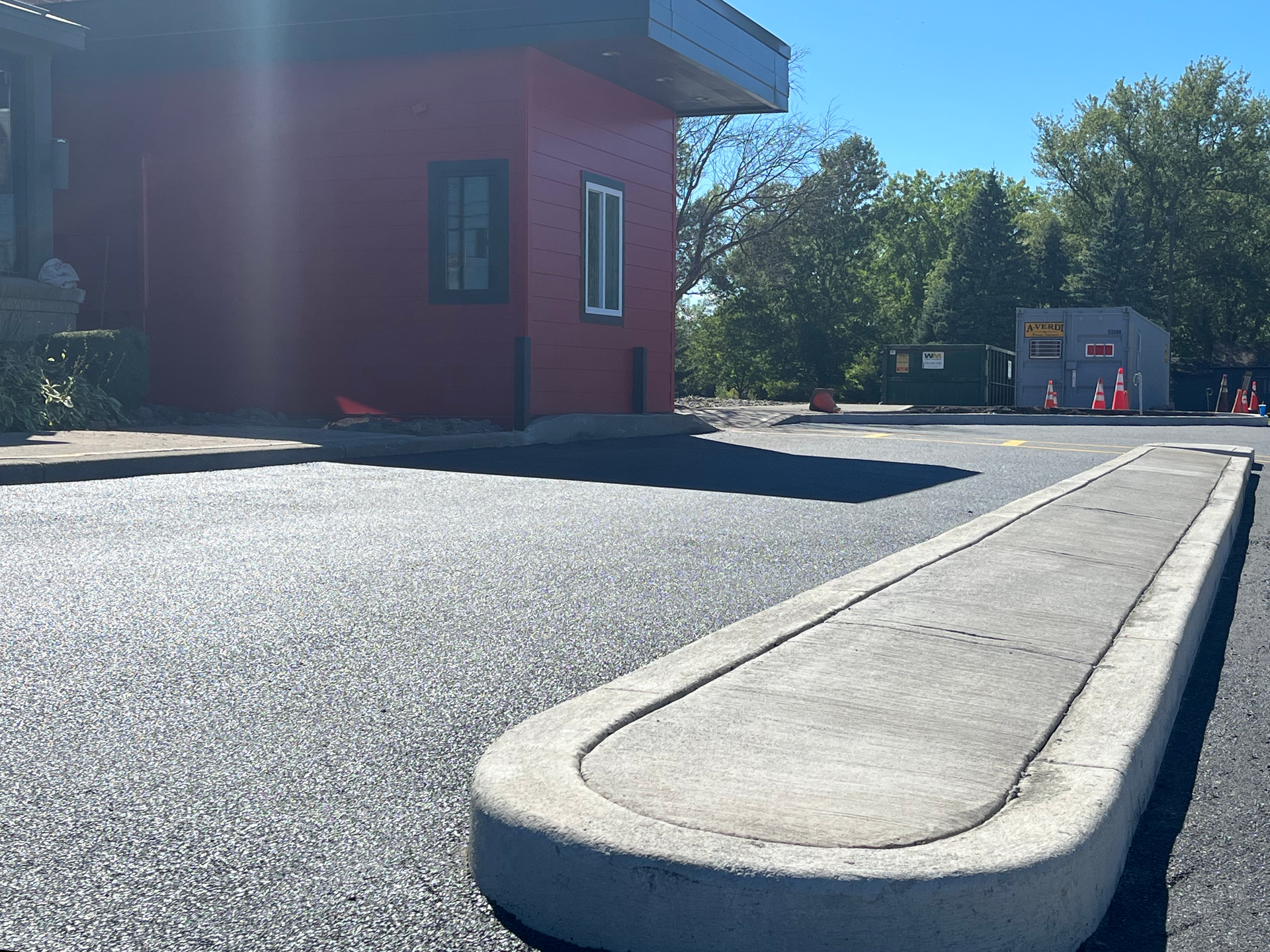 Universal Paving & Concrete team working on commercial paving for a large business complex in Rochester, NY, providing efficient and reliable paving solutions.