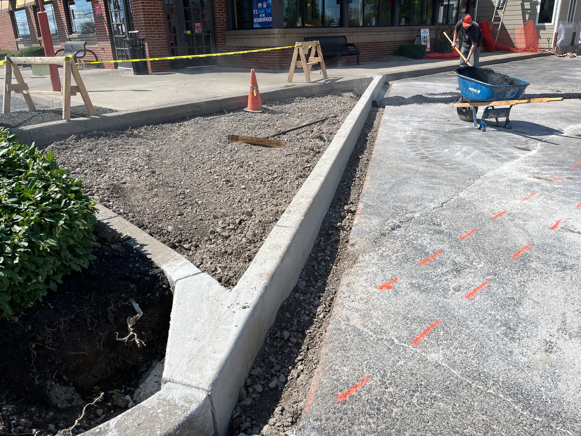 Universal Paving & Concrete team installing commercial asphalt paving for a business parking lot in Rochester, NY, designed for heavy traffic and durability.