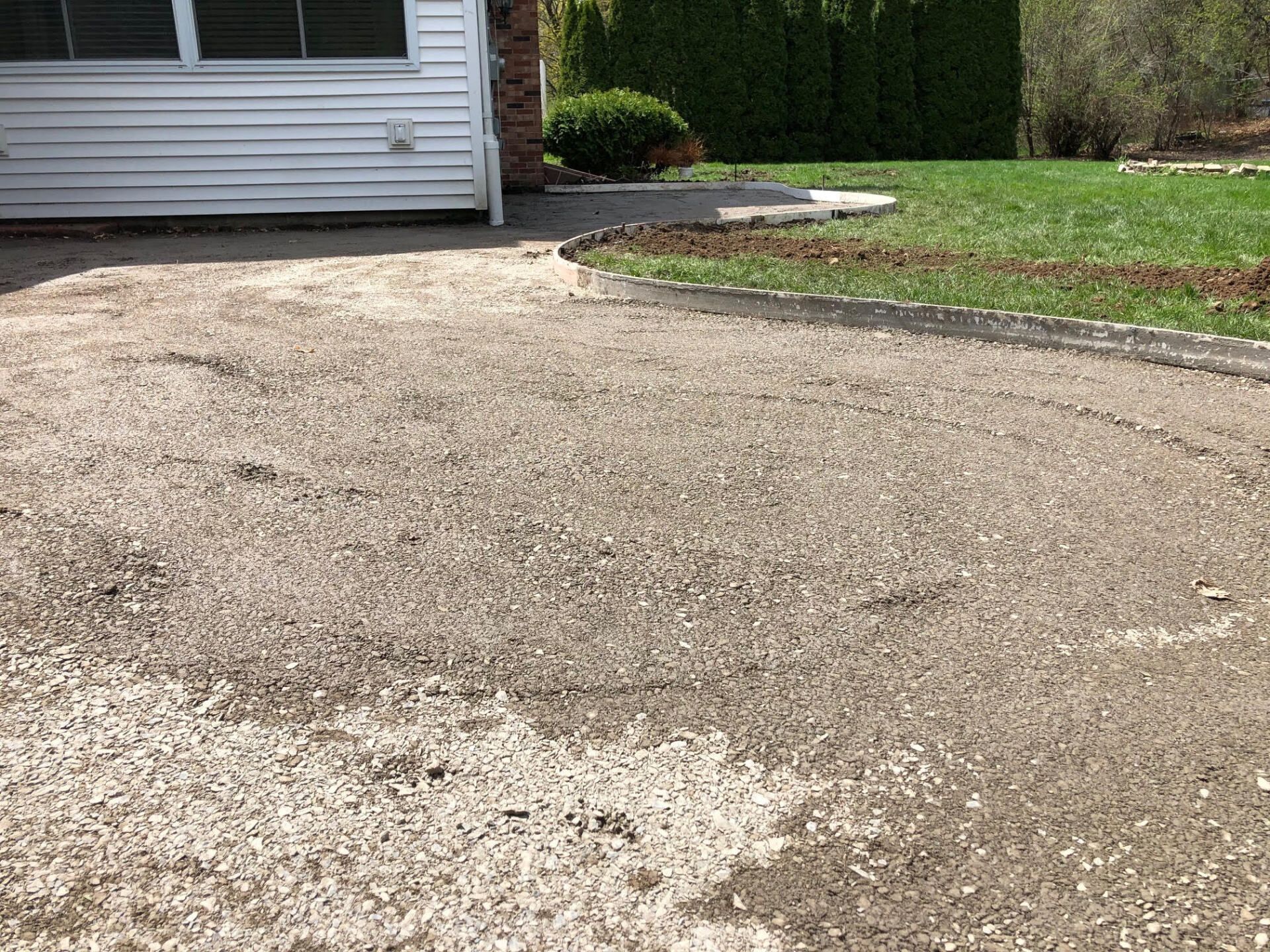 Stunning stamped concrete patio with a brick pattern, installed by Universal Paving & Concrete in Rochester, NY, enhancing outdoor living spaces with style.