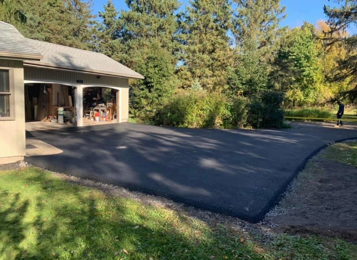 Close-up of asphalt driveway installation showing detailed surface texture, completed by Universal Paving & Concrete in Rochester, NY.