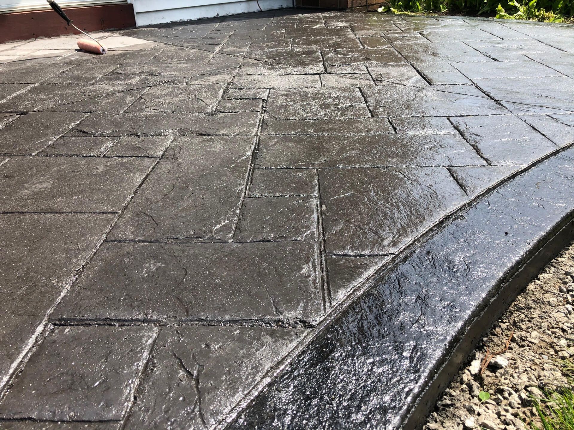 Stamped concrete patio installation in progress by Universal Paving & Concrete in Rochester, NY, showing the careful craftsmanship and detail in the design.