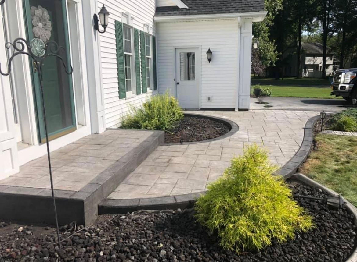 Stamped concrete porch installation by Universal Paving & Concrete in Rochester, NY, offering both style and lasting performance.