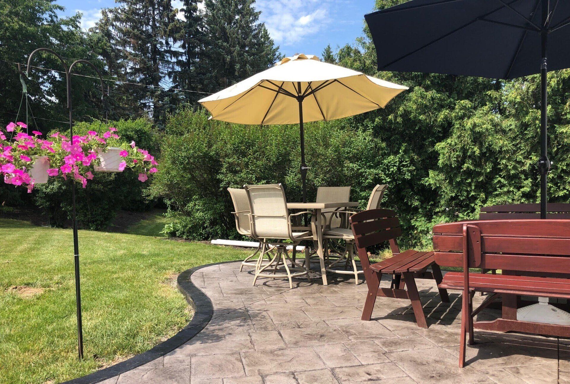 Stamped concrete patio featuring a slate-like design, installed by Universal Paving & Concrete in Rochester, NY, providing both beauty and durability for your yard.