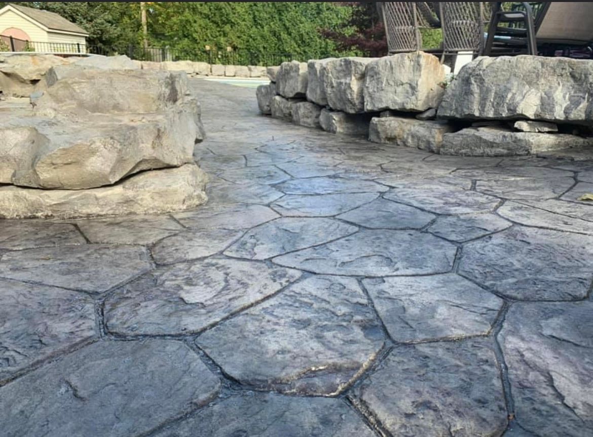Custom stamped concrete patio by Universal Paving & Concrete in Rochester, NY, with elegant detailing and patterns that enhance the look of any outdoor space.
