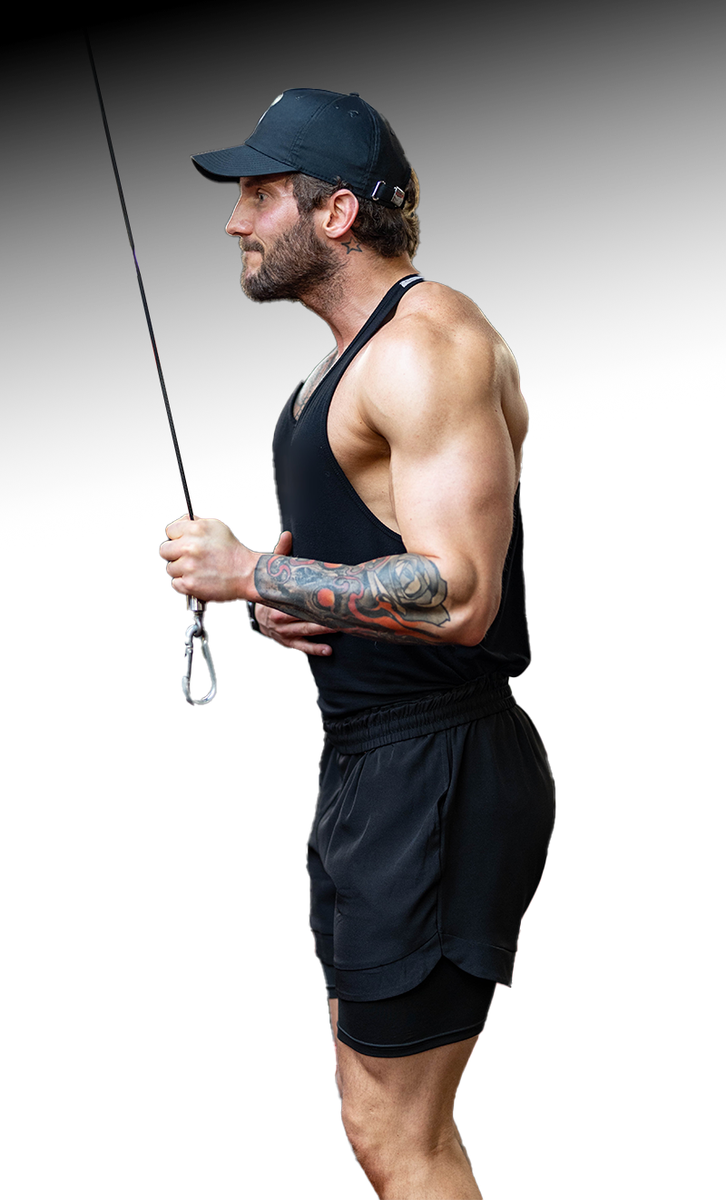 A man in a tank top and shorts is holding a rope.