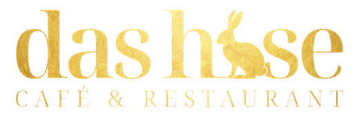 Goldenes „das hase“-Logo mit einem Hasen und dem Schriftzug „CAFÉ & RESTAURANT“ darunter