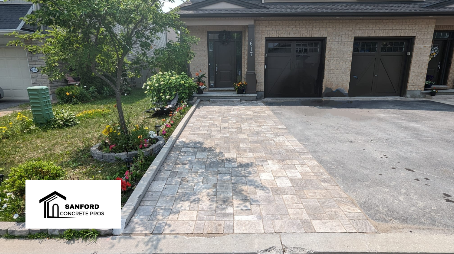 A brick house with a driveway in front of it.