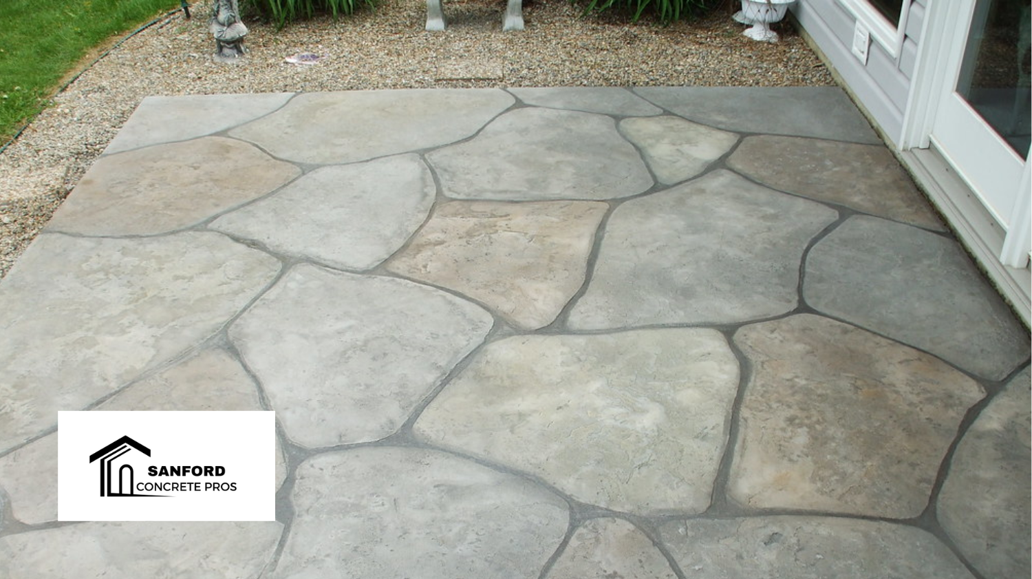 A stone patio with a house in the background