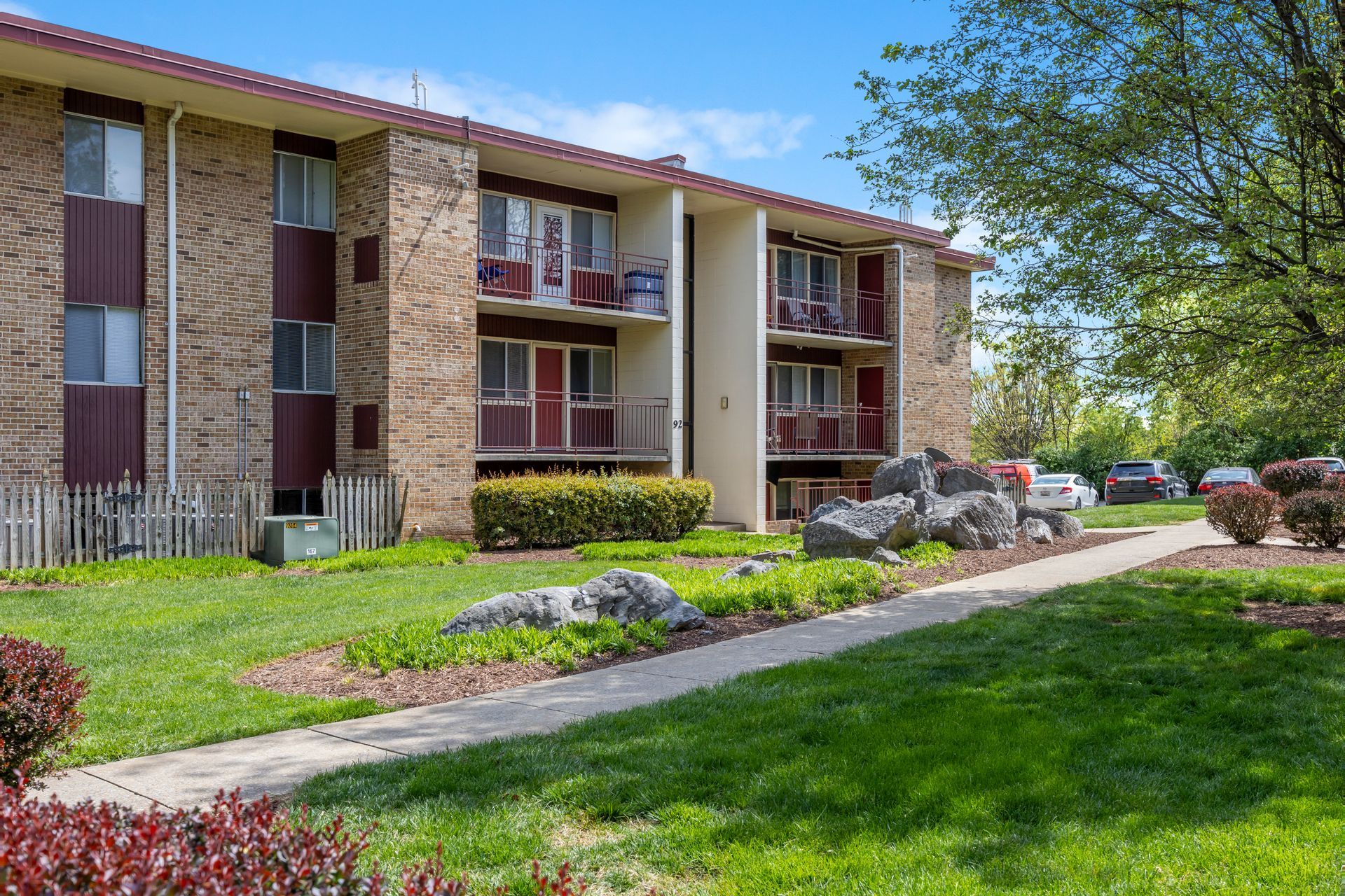 A large apartment building with a walkway leading to it.