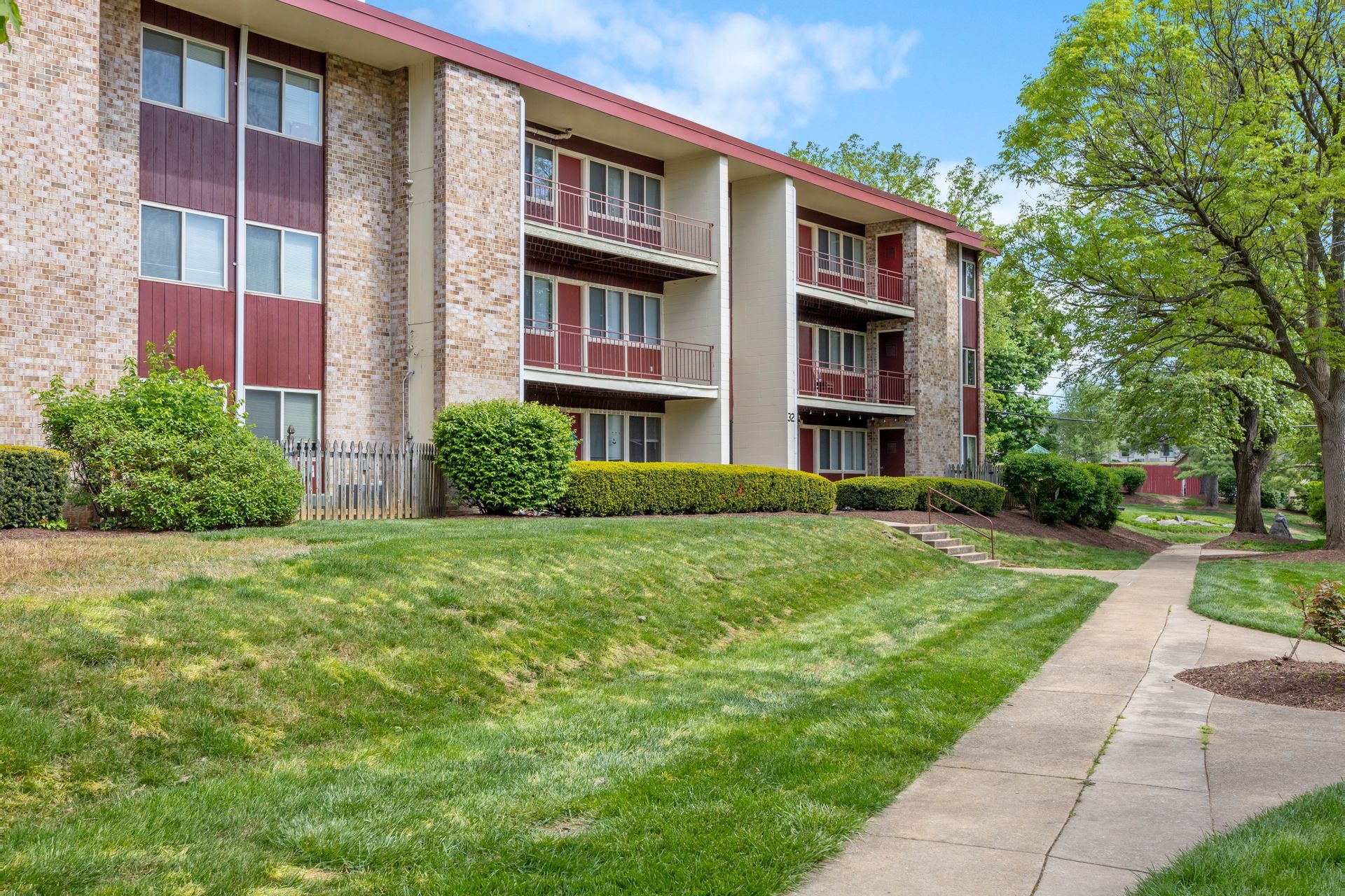 A large apartment building with a walkway leading to it.