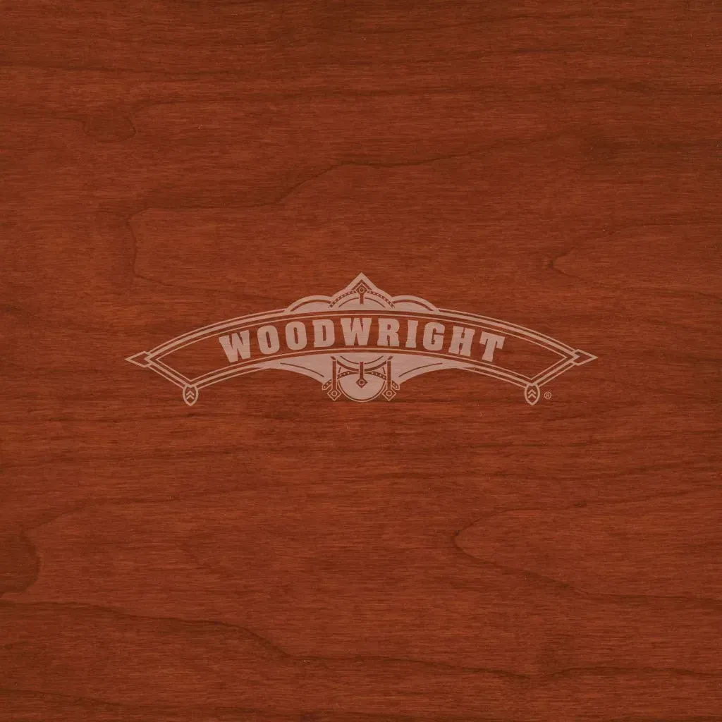 Cherry-stained wood background with the engraved word 