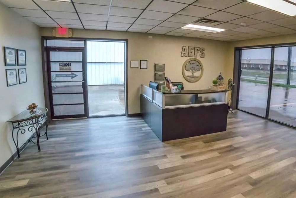 a reception area with a sign on the wall that says aefs