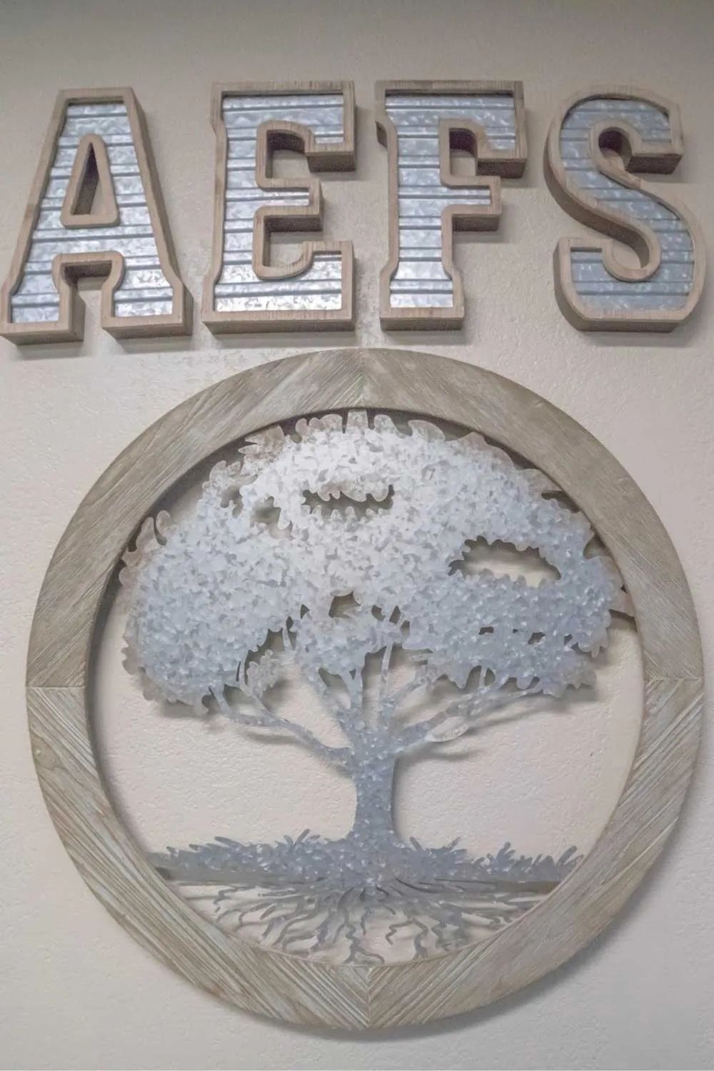 a sign that says aefs with a tree in the middle