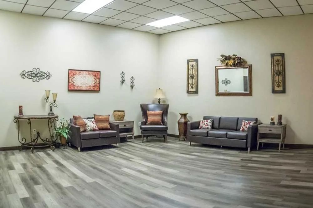 a living room with a couch and two chairs
