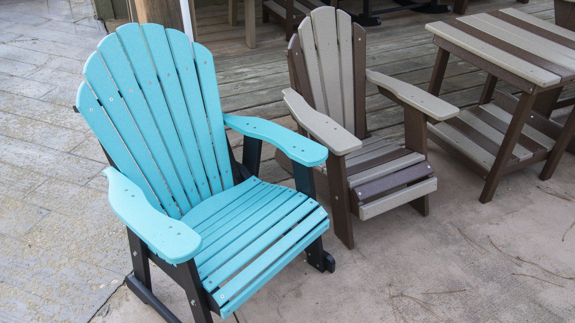 Blue and brown Adirondack chairs on a patio.