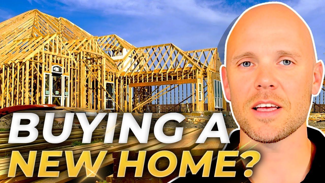 A bald man is standing in front of a house under construction.