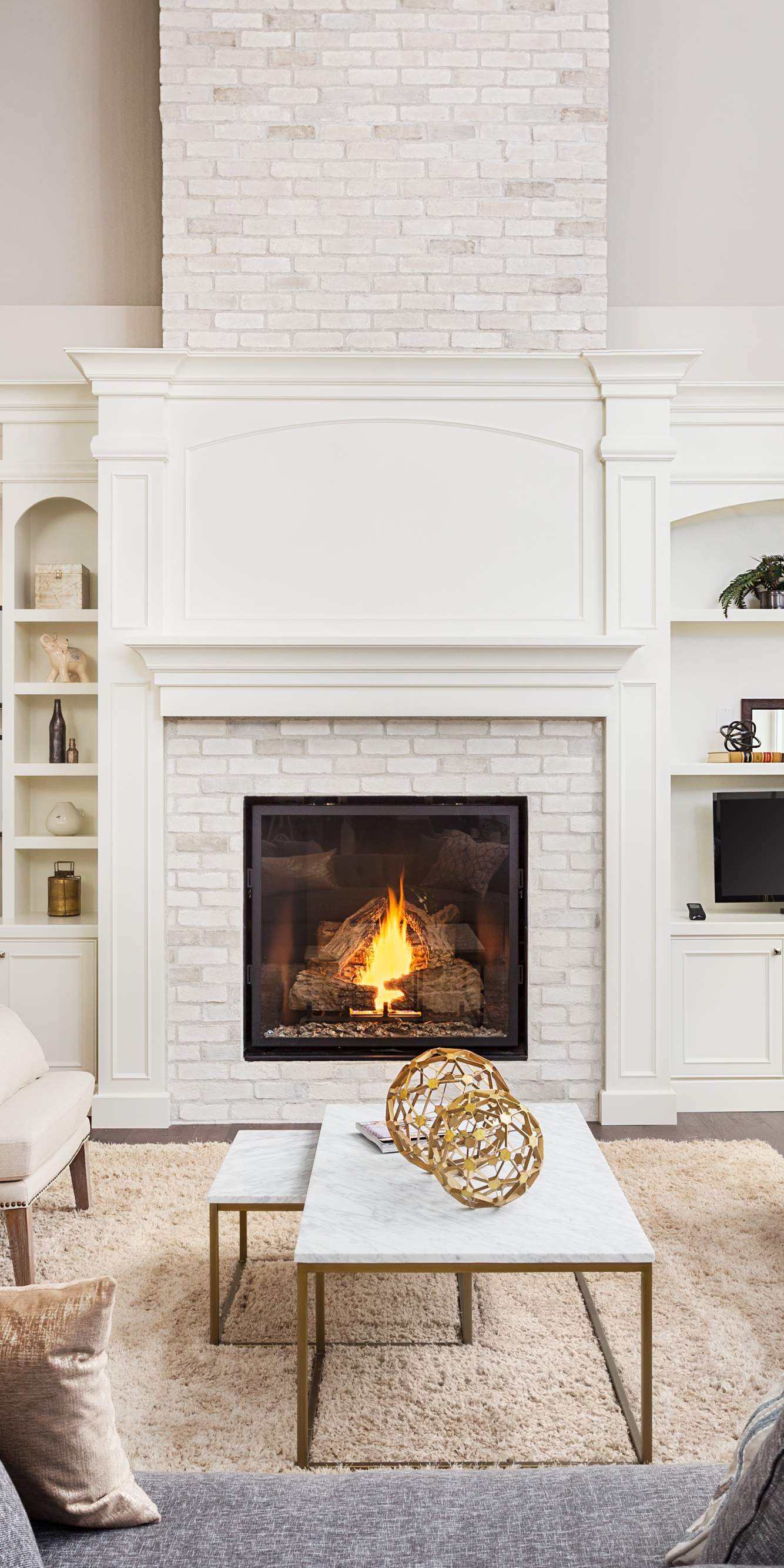 There is a fireplace in the middle of the living room.