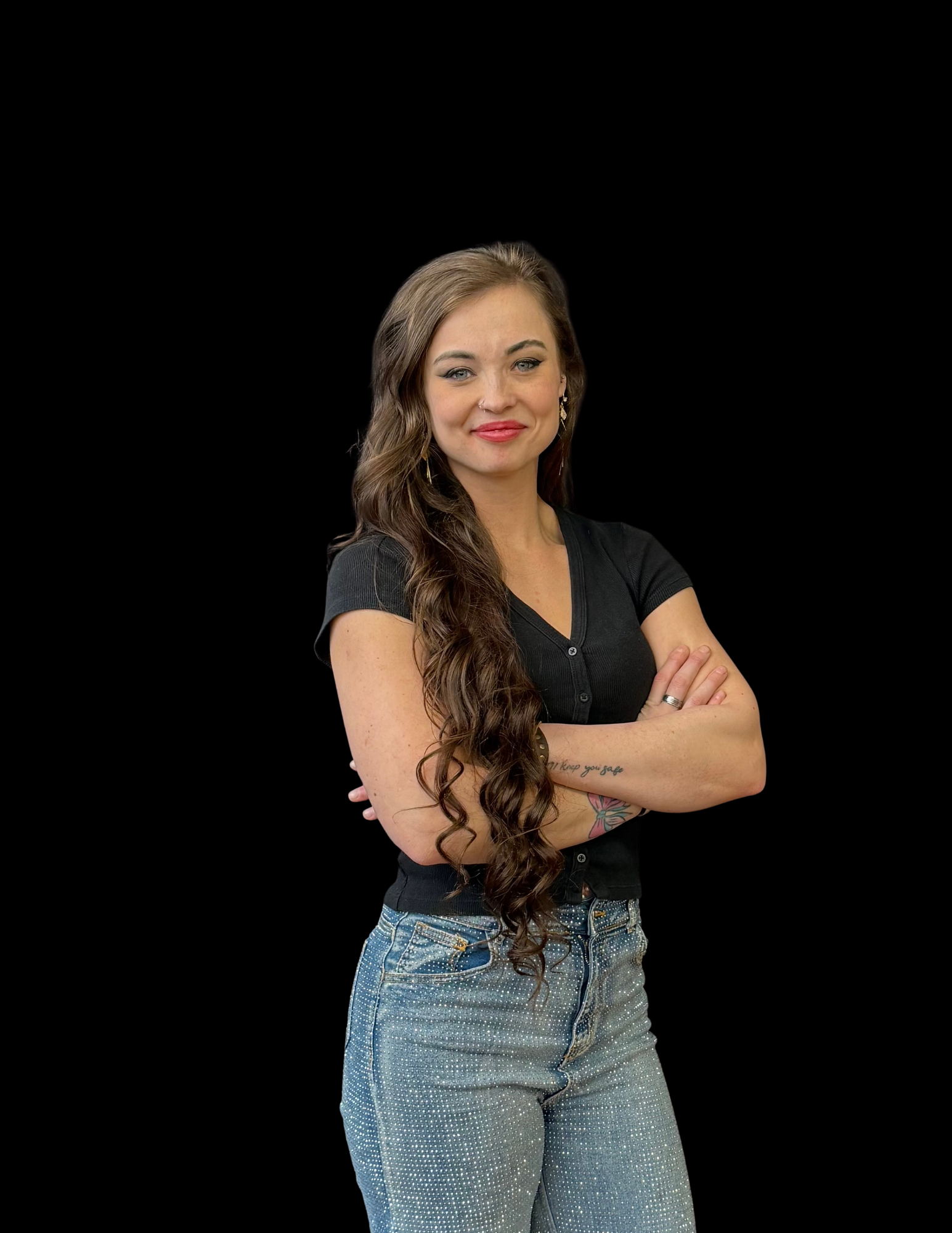A woman with long brown hair is smiling for a picture.