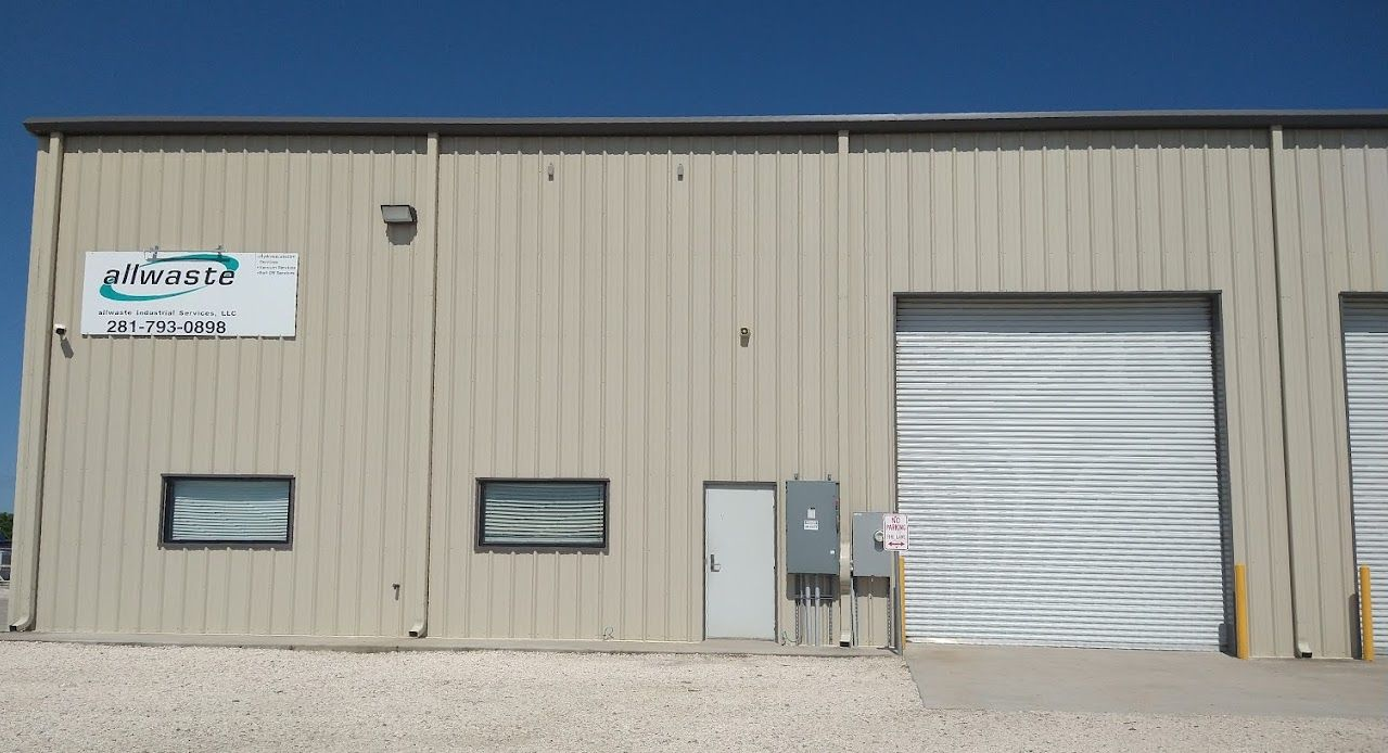 A building in Baytown, Texas with a sign on the side that says Allwaste Industrial Services, LLC