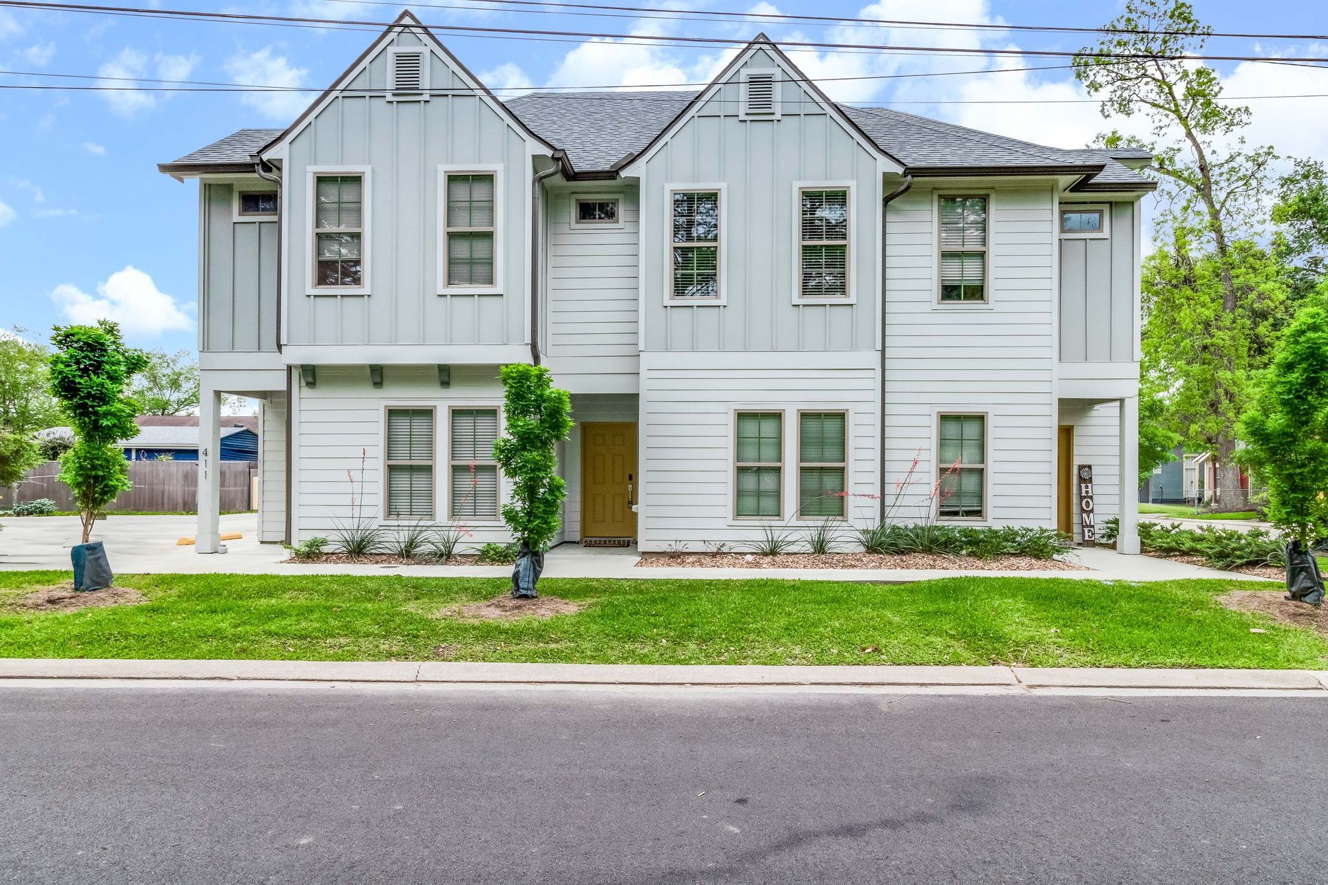 A large white house with a lot of windows is for sale.