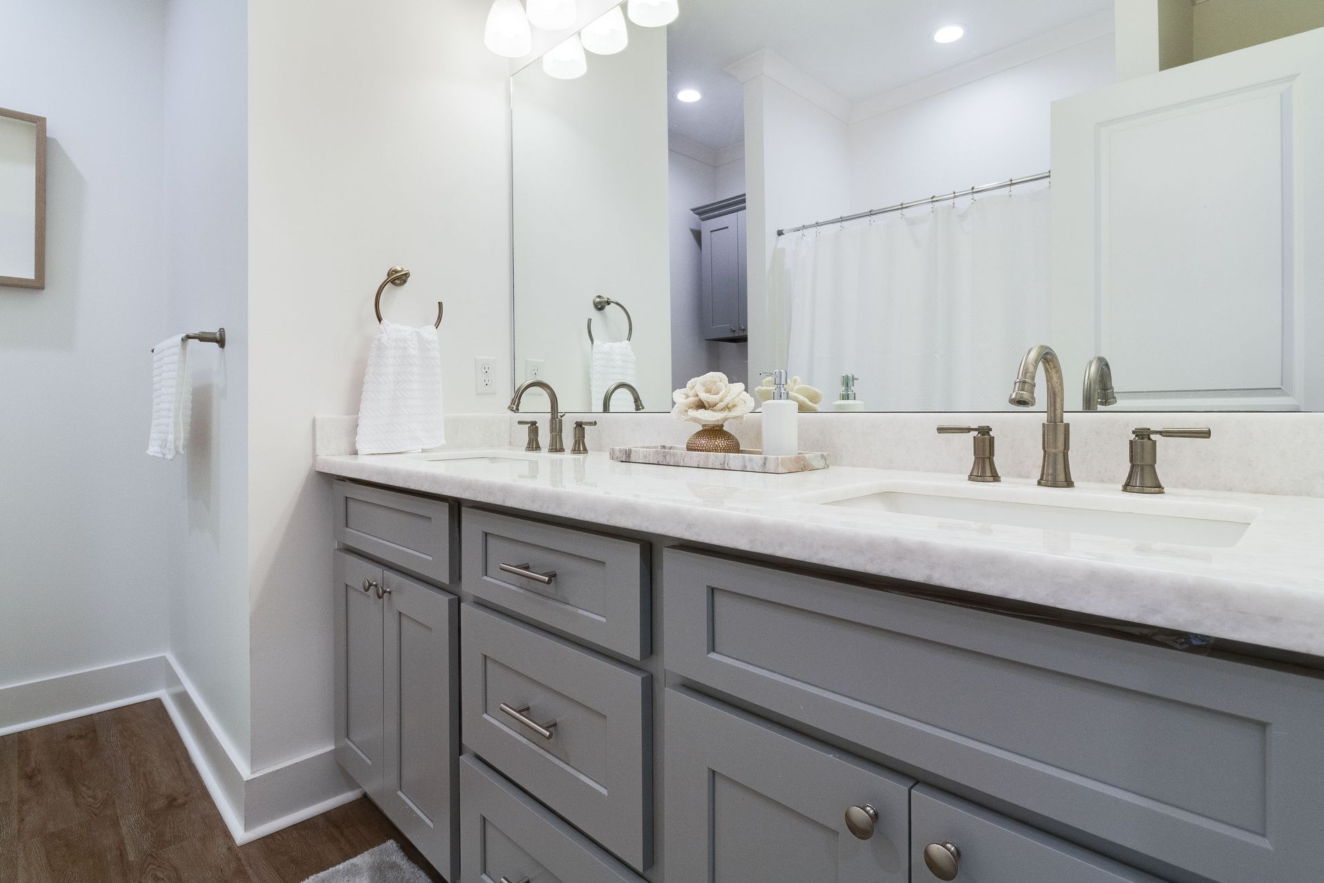 A bathroom with two sinks and a large mirror.