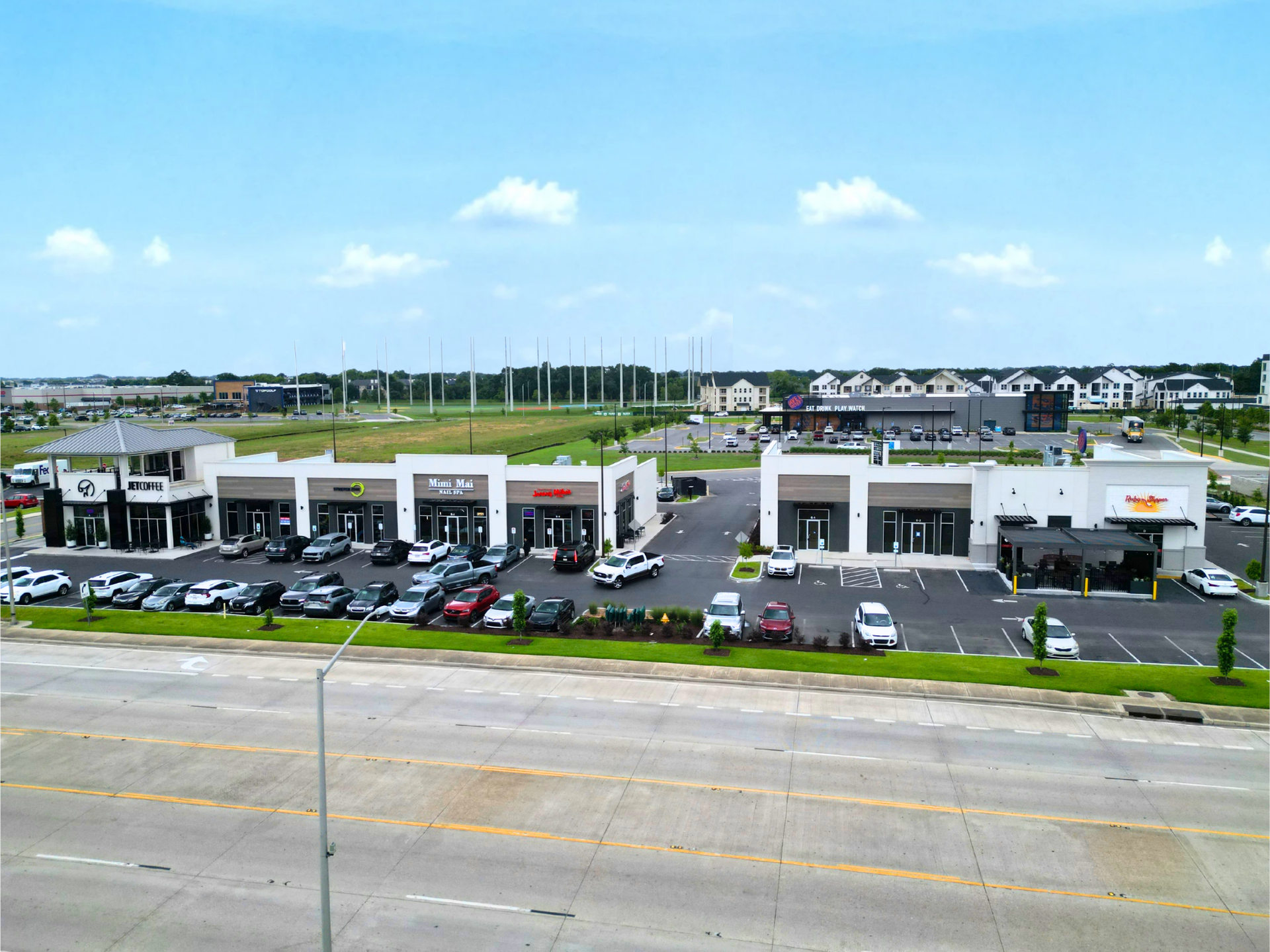 An aerial view of a car dealership with cars parked in front of it
