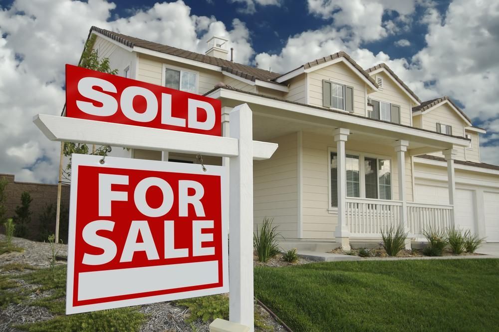 A House with A for Sale Sign in Front of It — Jarrett Lawrie Conveyancing in Parap, NT