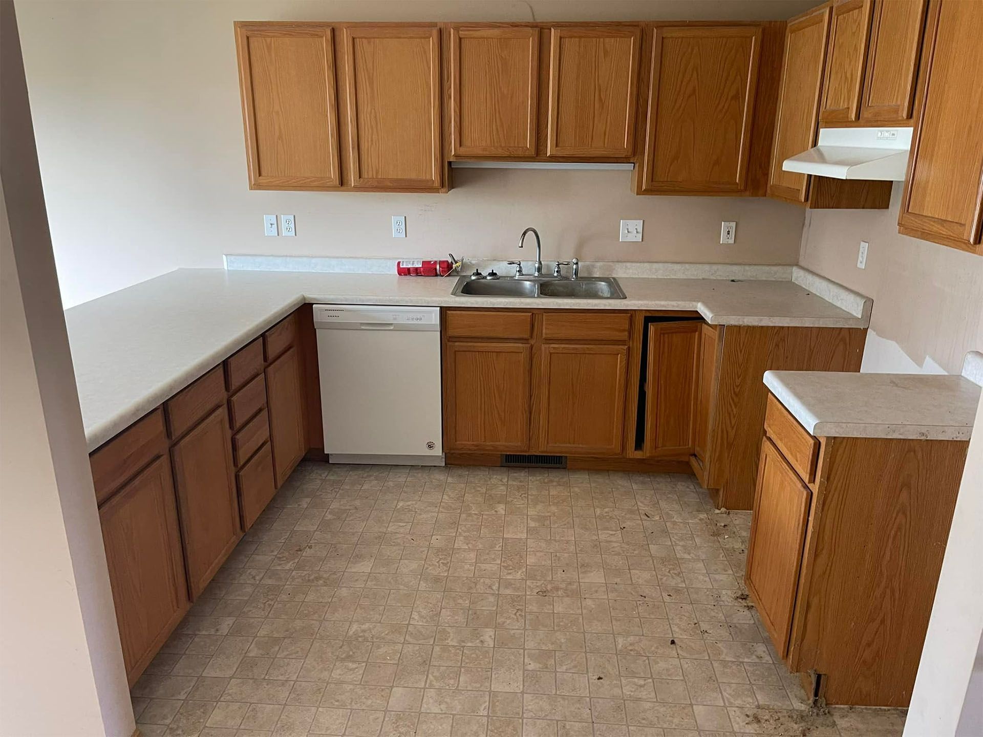 Kitchen with oak cabinets and white countertops