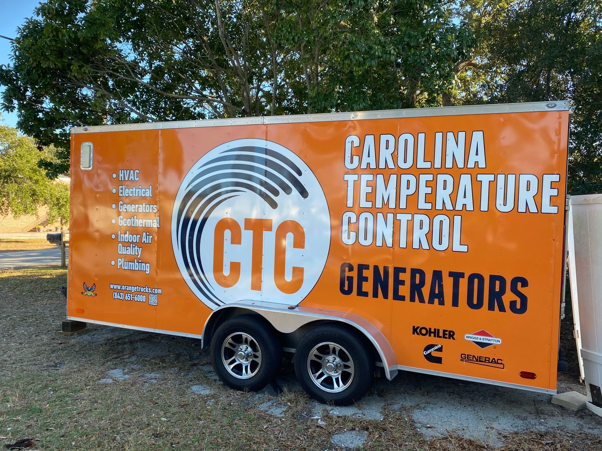 Orange trailer with “CTC” and “Carolina Temperature Control Generators” parked outdoors.
