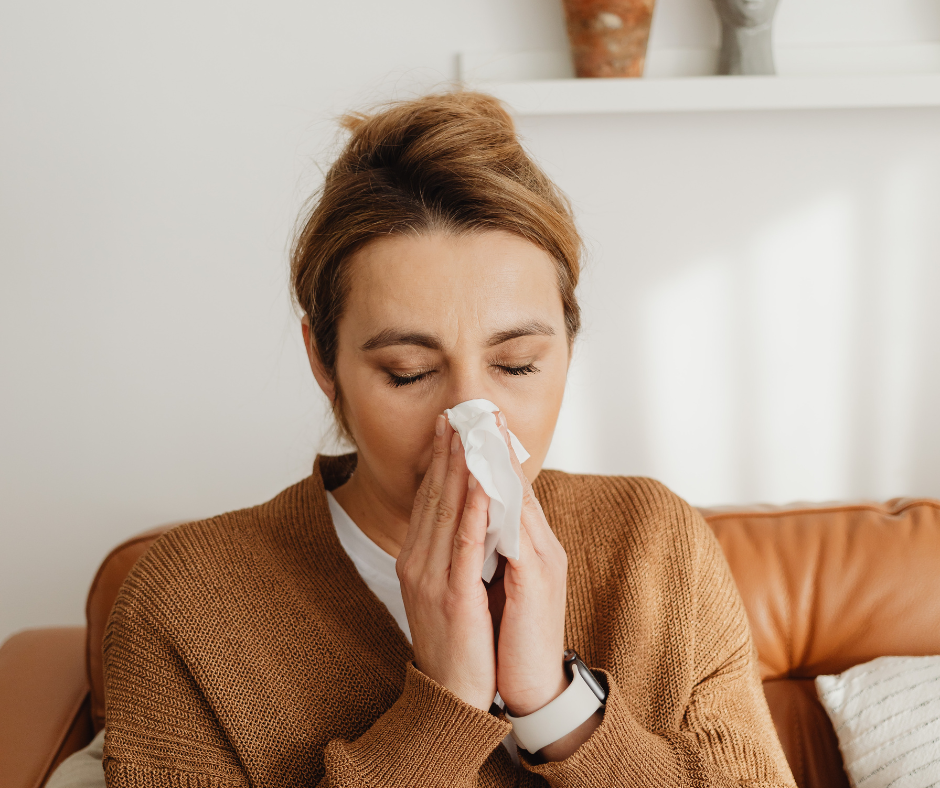 Woman with allergies blowing her nose