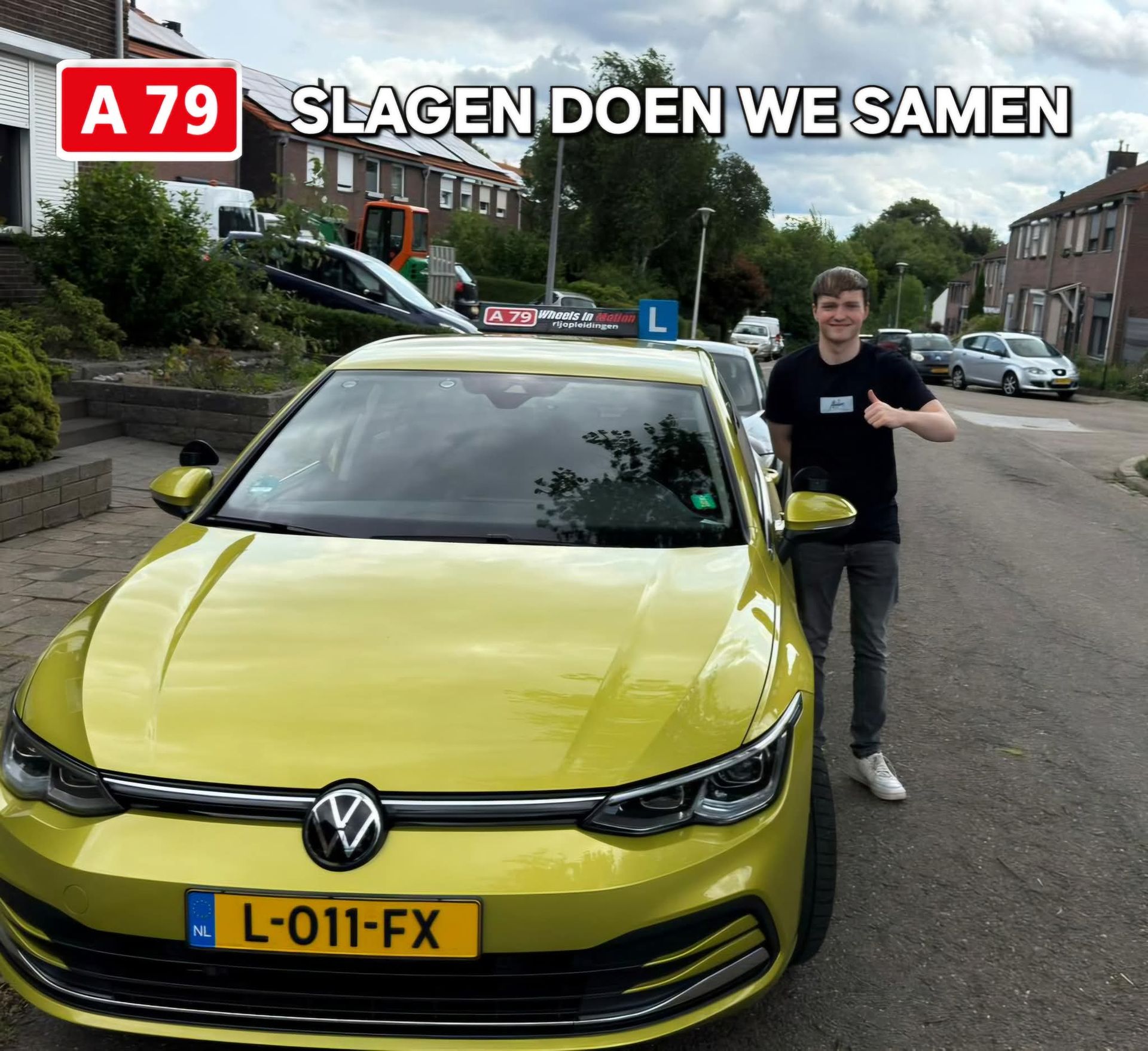 Een man steekt zijn duim omhoog naast een gele auto met een Nederlands kenteken.