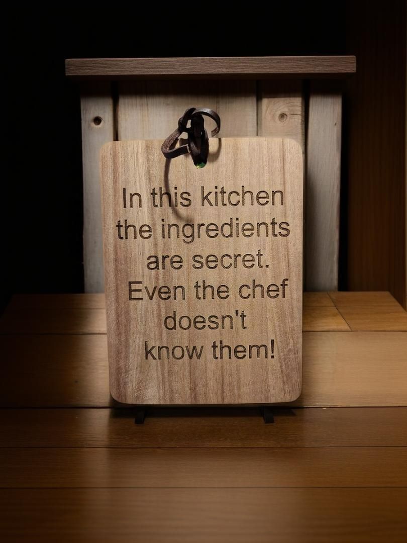 A wooden sign that says `` in this kitchen the ingredients are secret . even the chef doesn 't know them ! ''