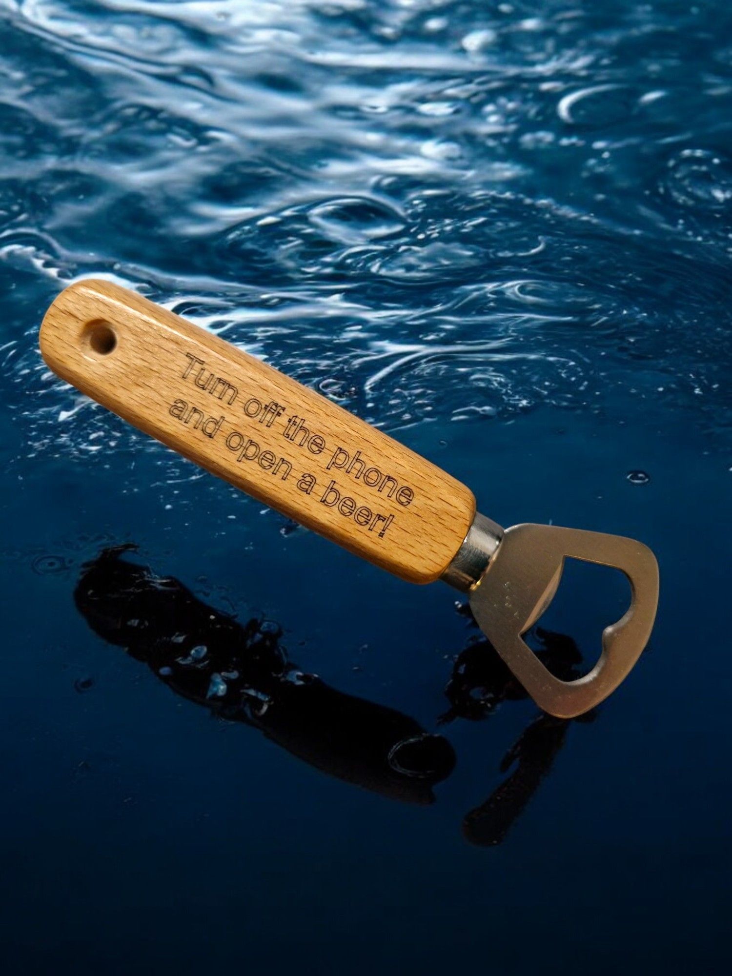 A bottle opener with a wooden handle is floating in the water.