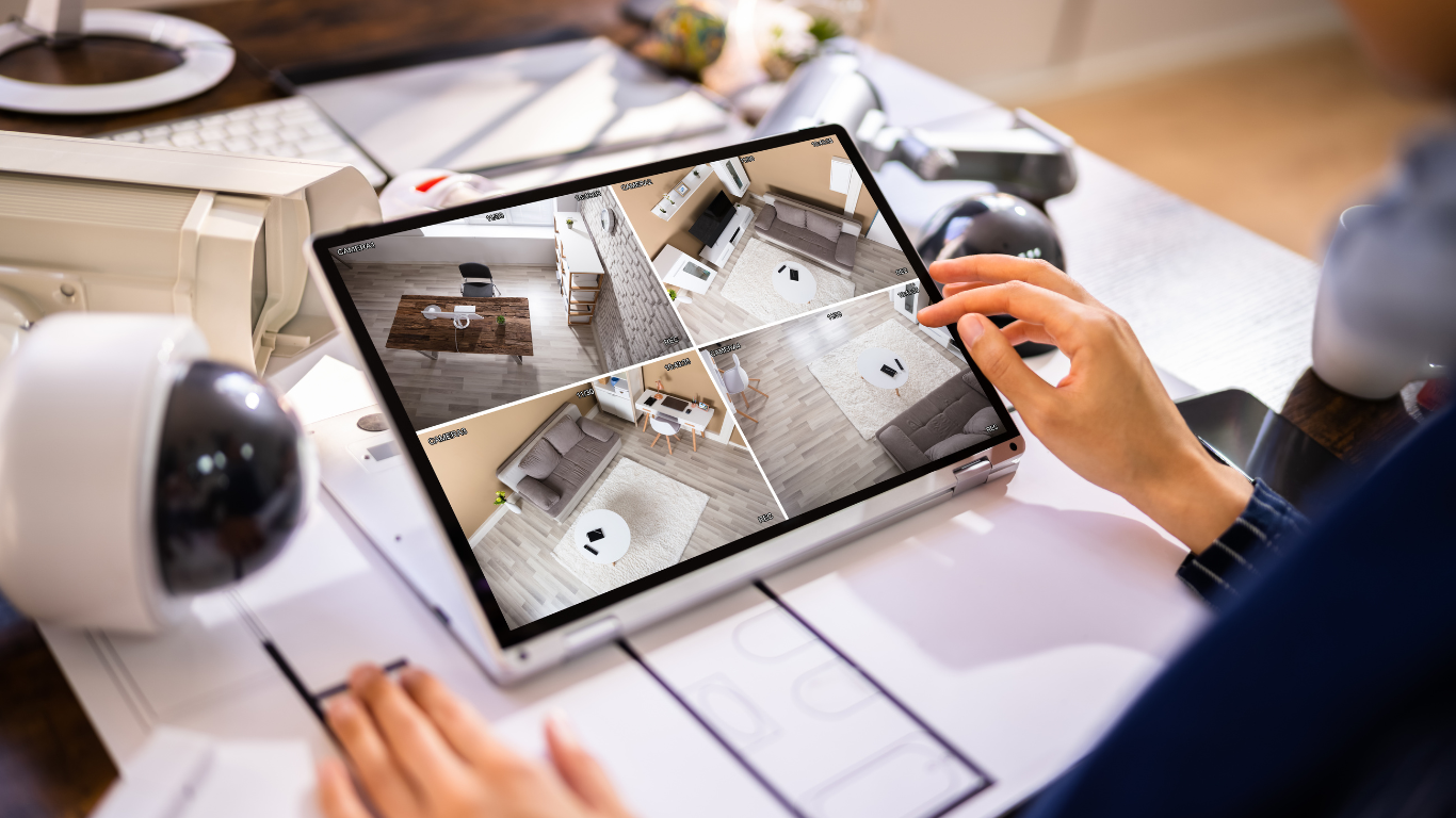 A person is looking at a security camera on a tablet.
